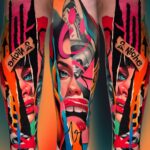 A vibrant, colorful sleeve tattoo depicting a woman's face with bright red lips and blue eyes.
