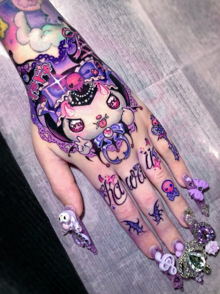A hand decorated with colorful kawaii tattoos and long, ornate purple acrylic nails.