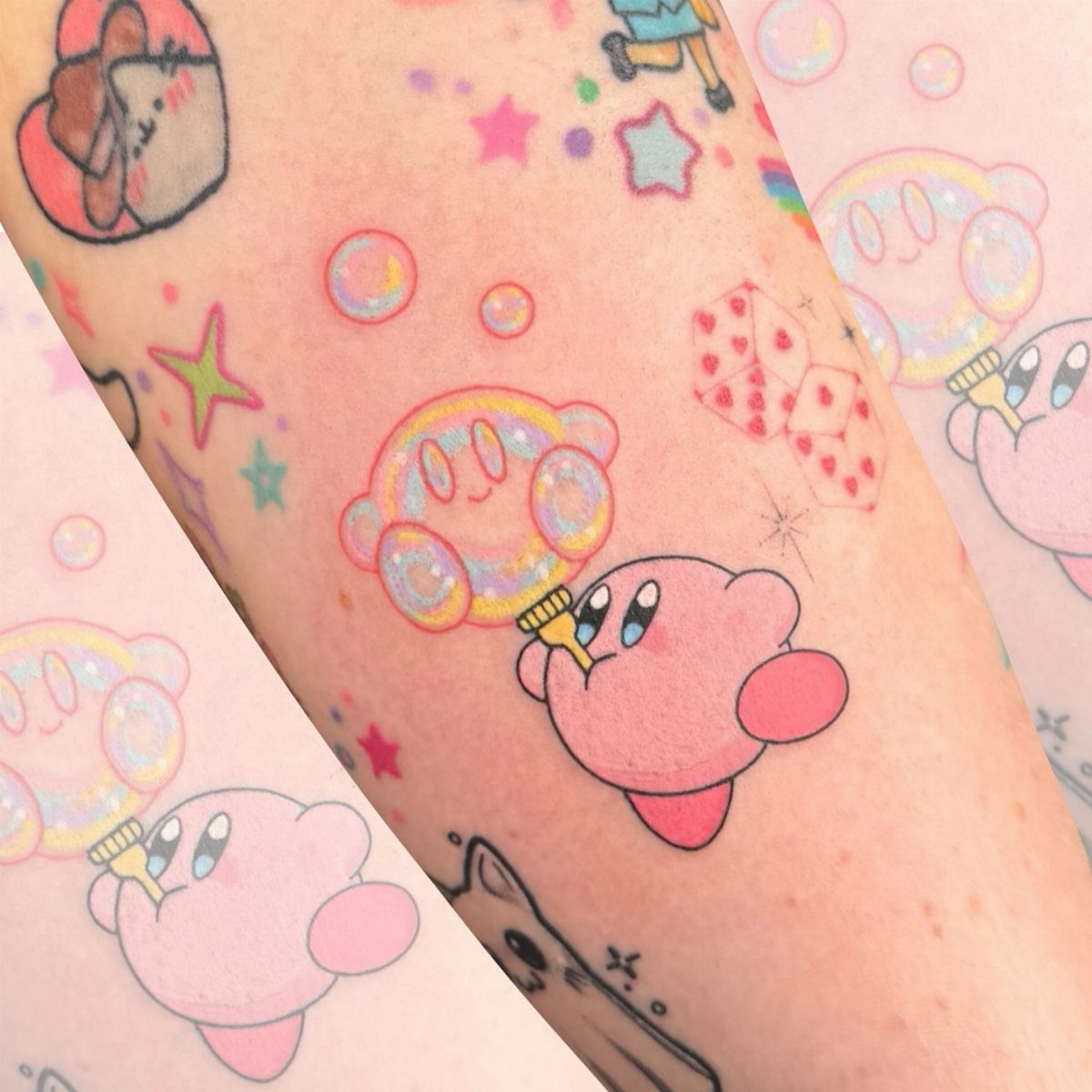 Small colorful cartoon tattoos of Kirby and stars scattered across a person's arm.